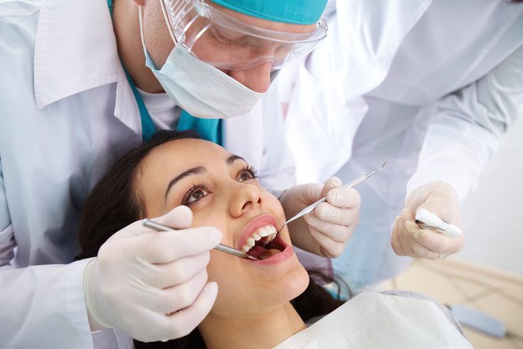 Dentist and assistant examining patient at Corio Dental Surgery